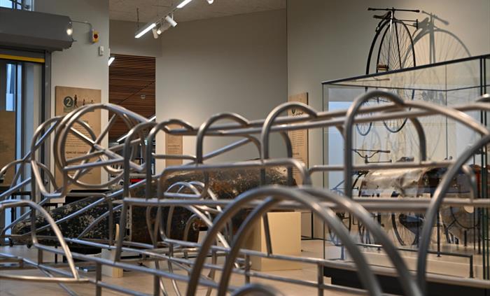 Steel frame model of Babs in the foreground with the tail of Sir Malcolm Campbell's BlueBird in the background in the Museum of Land Speed